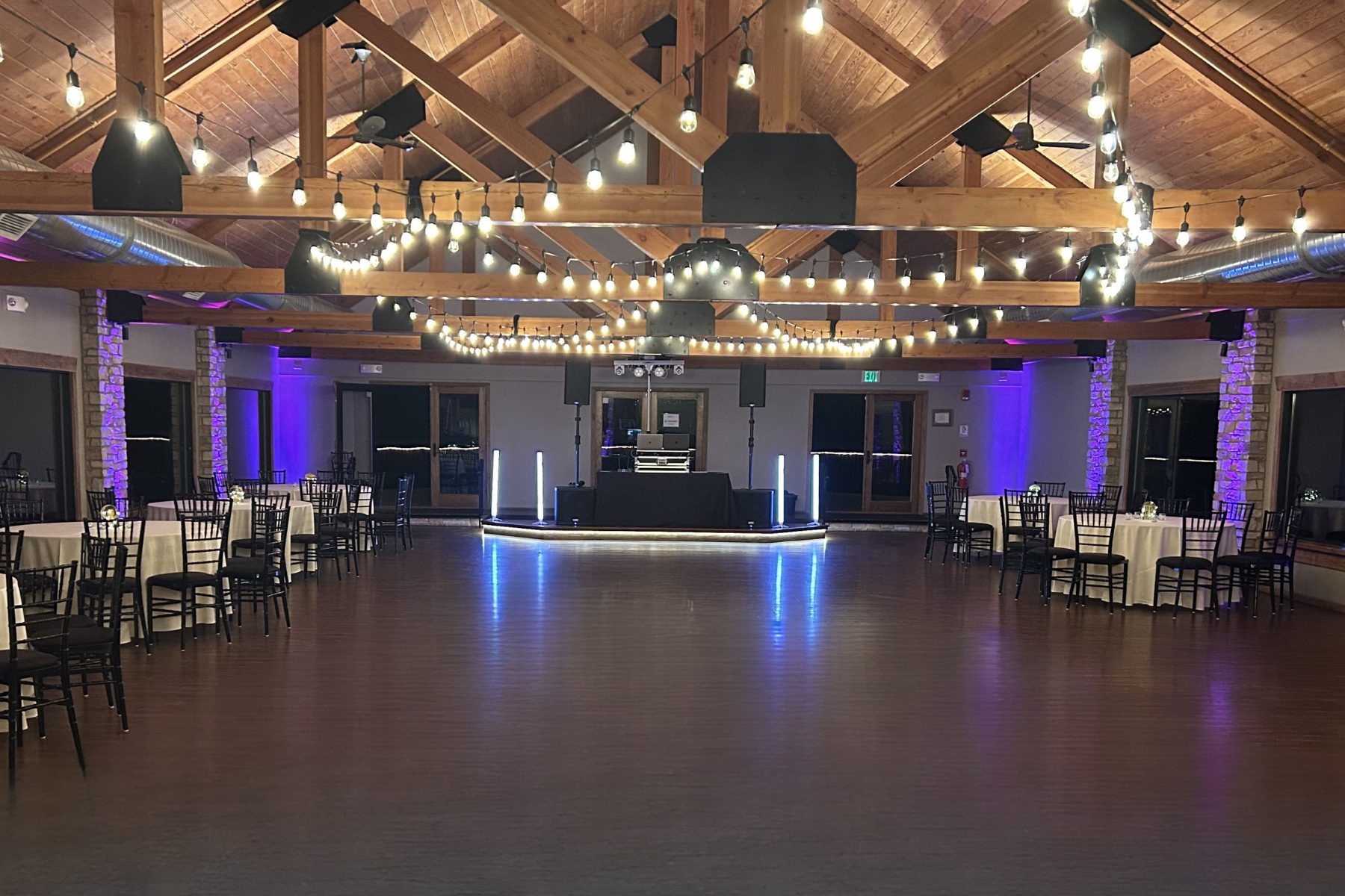 Fishermens Inn Wedding DJ Dance Floor Elburn IL Wedding reception dance floor at Fishermens Inn in Elburn Illinois with DJ setup, string lights, and rustic wood beams